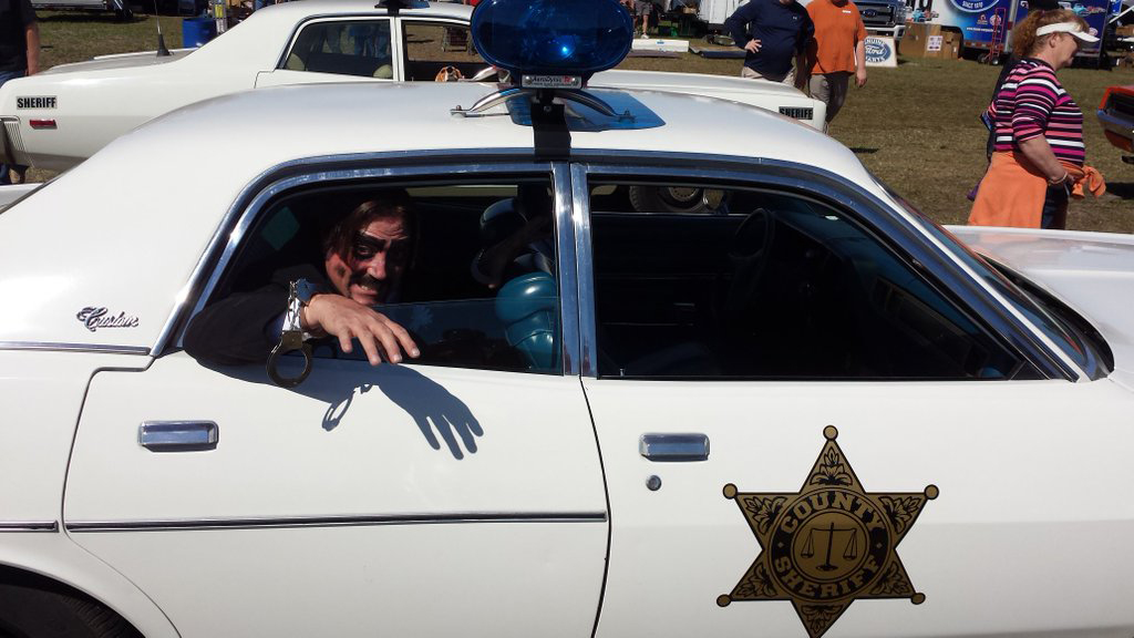 Dr. Paul Bearer in a police car
